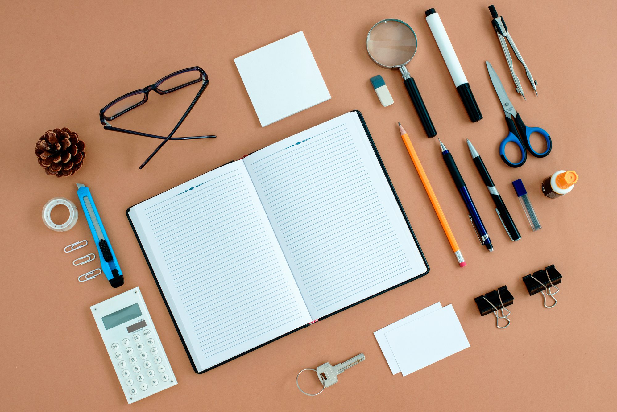 Office supplies neatly rrganized around notebook